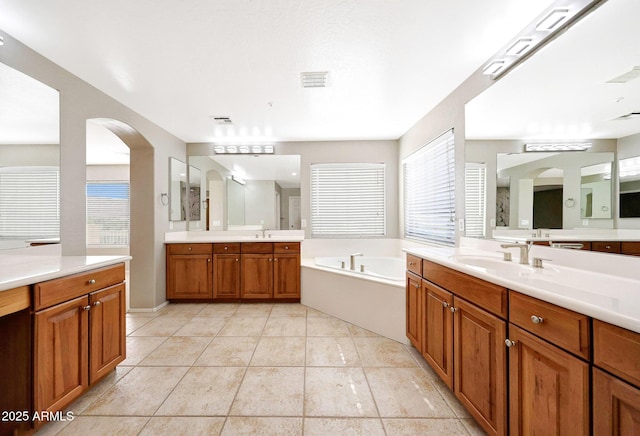 5726 W Park View Ln, Glendale, AZ 85310 - bathroom featuring a garden tub, tile patterned flooring, and two vanities