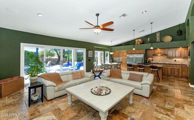 living room featuring ceiling fan and high vaulted ceiling