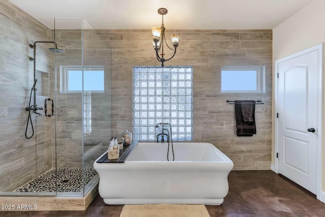 bathroom featuring separate shower and tub, tile walls, and a notable chandelier