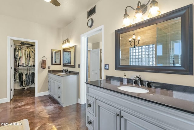 bathroom featuring vanity, ceiling fan with notable chandelier, and concrete floors