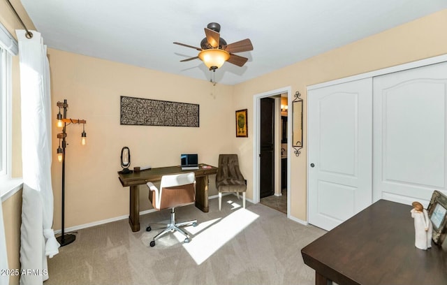 carpeted office featuring ceiling fan