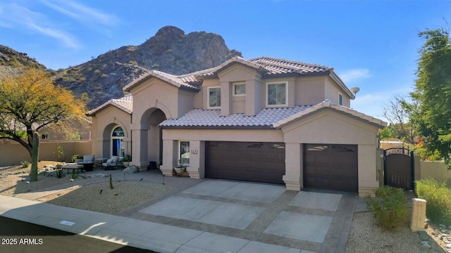 mediterranean / spanish-style home with a garage and a mountain view