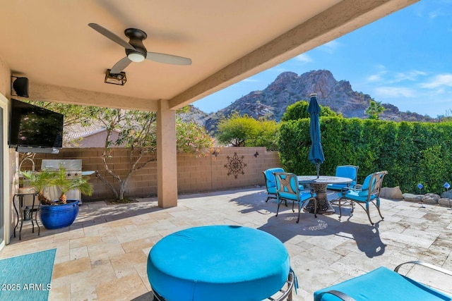 view of patio featuring a mountain view and ceiling fan