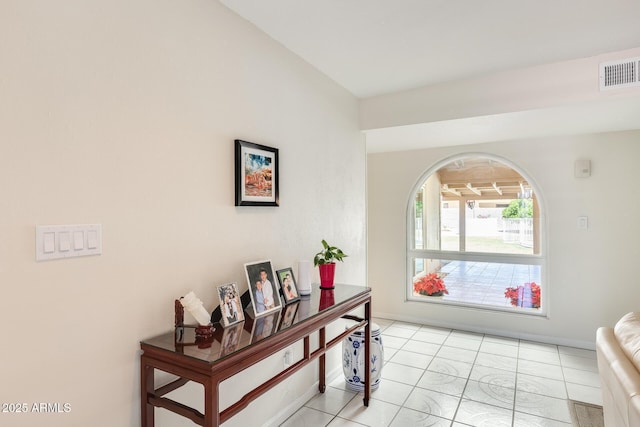 interior space featuring light tile patterned flooring and visible vents