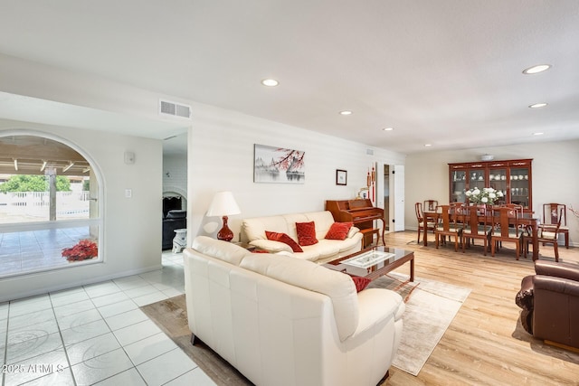 living area featuring visible vents and recessed lighting