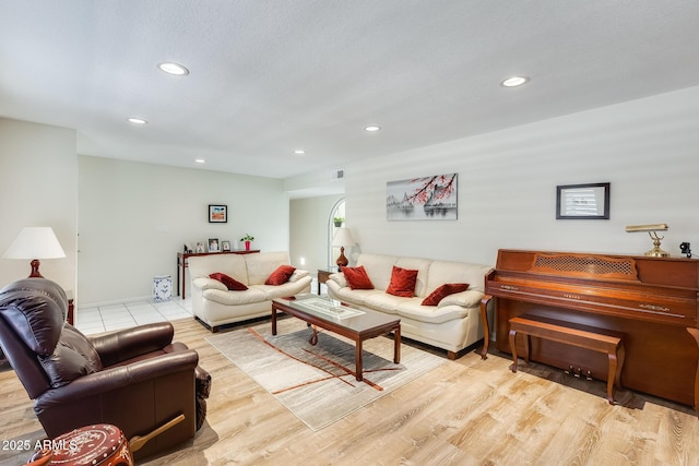 living area with visible vents, recessed lighting, and wood finished floors