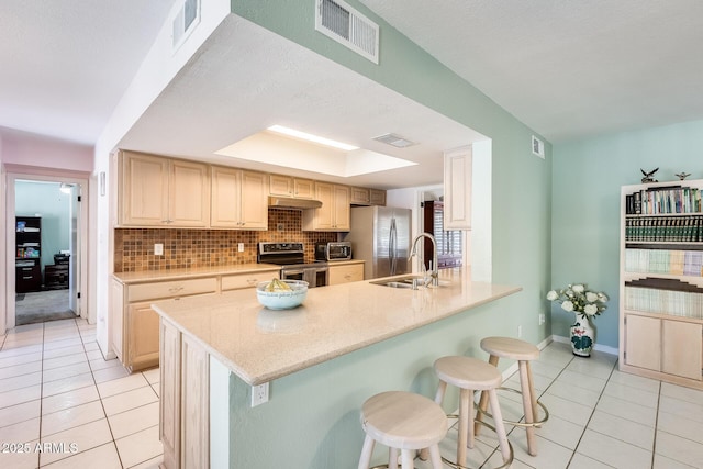 kitchen featuring light tile patterned floors, stainless steel appliances, visible vents, and a sink