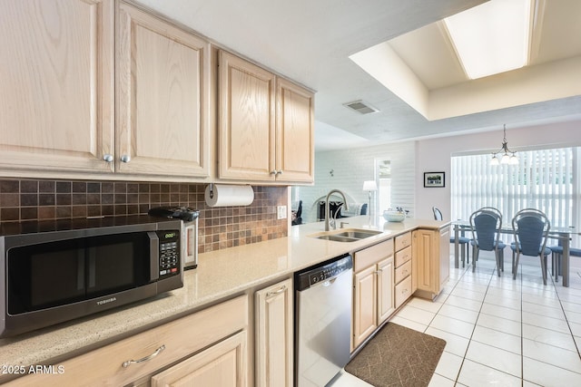 kitchen featuring a sink, visible vents, light brown cabinetry, light tile patterned floors, and appliances with stainless steel finishes