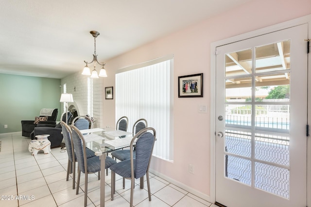dining room featuring light tile patterned floors and baseboards
