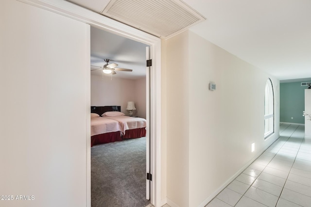 hallway with light tile patterned floors and visible vents