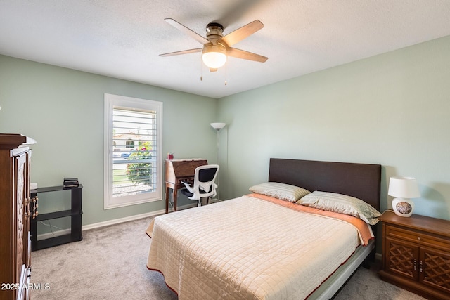bedroom with carpet, baseboards, and a ceiling fan