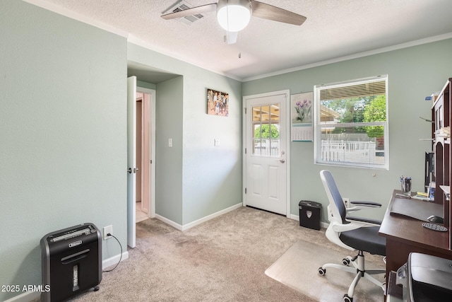 office space featuring a textured ceiling, carpet floors, a ceiling fan, and visible vents