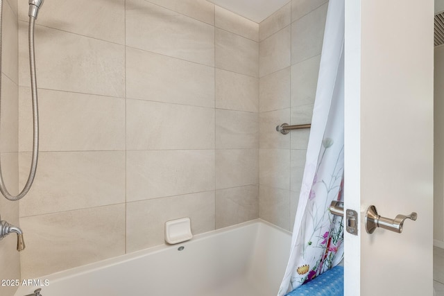 bathroom with shower / tub combo with curtain