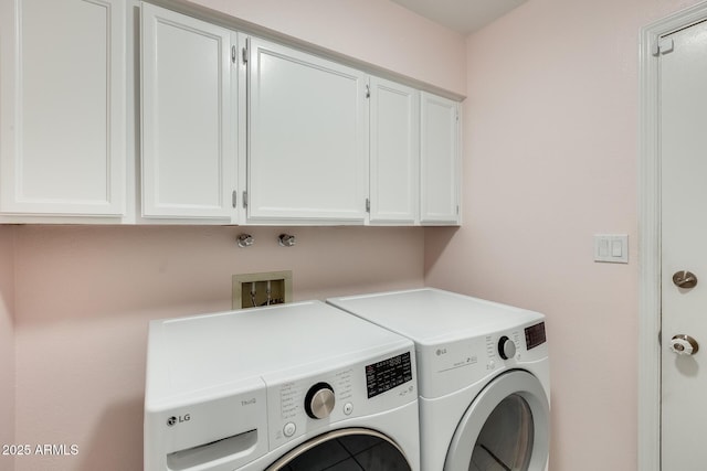laundry room featuring washing machine and dryer and cabinet space