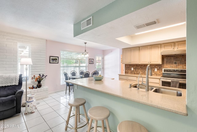 kitchen with light tile patterned floors, visible vents, a sink, and electric range