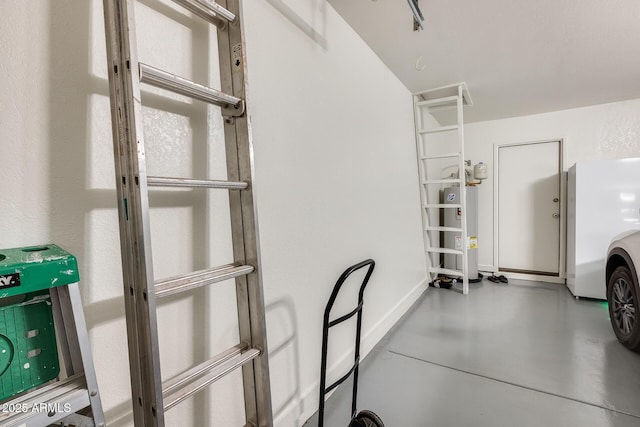 garage featuring water heater and baseboards