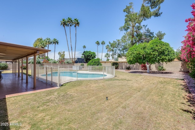 view of pool featuring a yard, a patio, a fenced in pool, and a fenced backyard