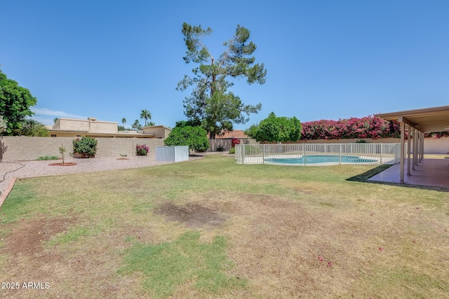 view of yard featuring a patio, a fenced in pool, and a fenced backyard