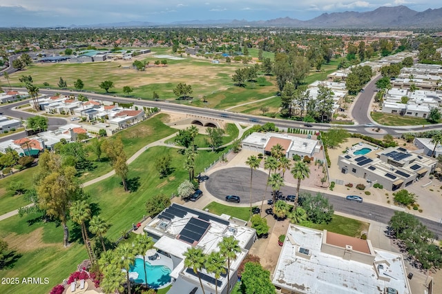 birds eye view of property with a mountain view, view of golf course, and a residential view