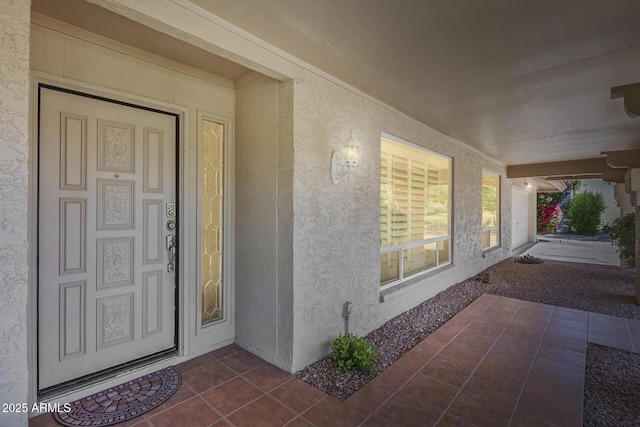 property entrance featuring stucco siding and a porch