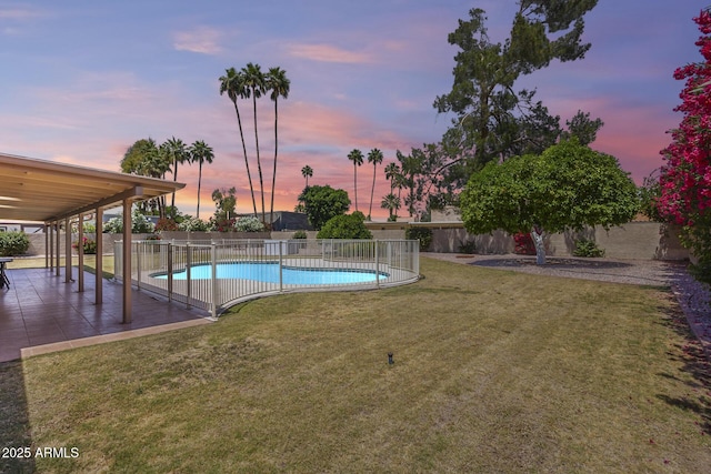 view of swimming pool featuring a yard, a patio, a fenced in pool, and a fenced backyard