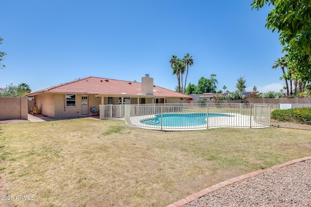 view of pool with a lawn, a patio area, a fenced in pool, and fence