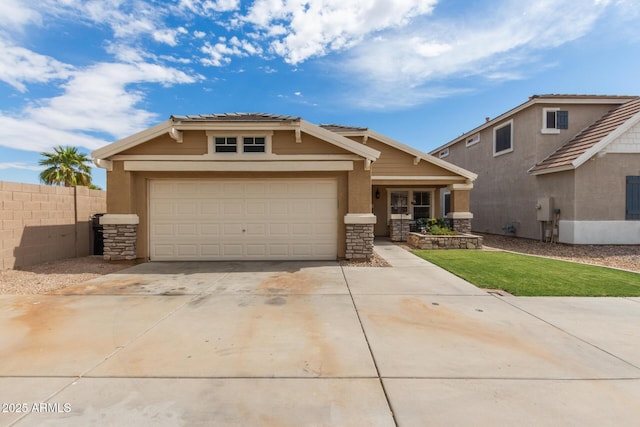 view of front facade with fence, stone siding, driveway, and a garage