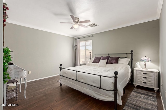 bedroom featuring crown molding, baseboards, wood finished floors, and a ceiling fan