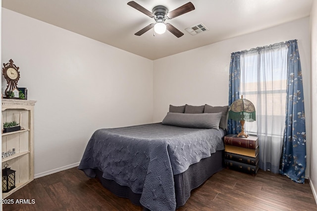 bedroom with wood finished floors, baseboards, and ceiling fan