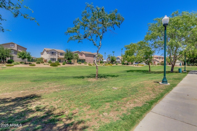 view of community featuring a residential view and a yard