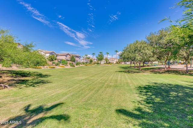 view of green lawn with a residential view