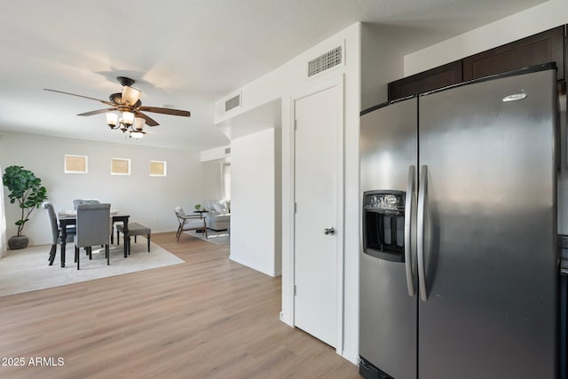 kitchen with ornamental molding, ceiling fan, stainless steel refrigerator with ice dispenser, dark brown cabinets, and light hardwood / wood-style flooring