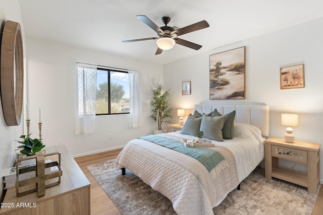 bedroom with light hardwood / wood-style flooring and ceiling fan