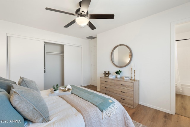 bedroom with connected bathroom, a closet, ceiling fan, and light wood-type flooring