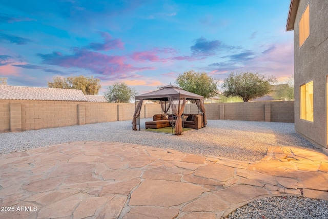 patio terrace at dusk featuring a gazebo