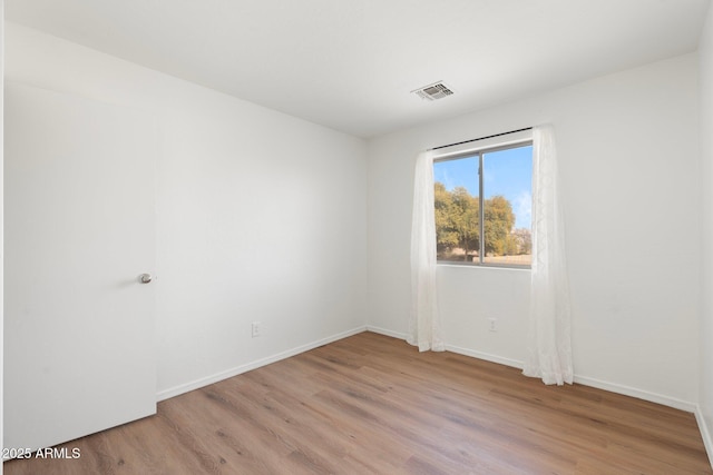 unfurnished room featuring light hardwood / wood-style floors