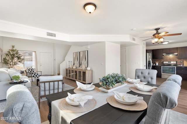 dining room with wood-type flooring and ceiling fan