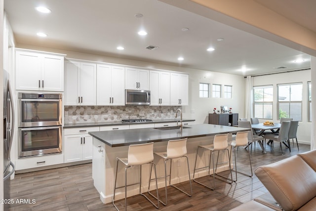 923 W Yellowstone Way, Chandler, AZ 85248 - kitchen featuring stainless steel appliances, dark countertops, backsplash, and recessed lighting
