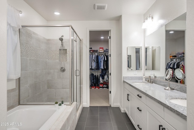 923 W Yellowstone Way, Chandler, AZ 85248 - bathroom with a walk in closet, a shower stall, tile patterned flooring, double vanity, and a garden tub