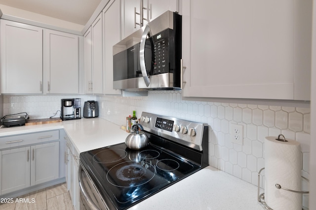 155 N Lakeview Blvd Unit 268, Chandler, AZ 85225 - kitchen featuring appliances with stainless steel finishes, light countertops, decorative backsplash, and gray cabinets