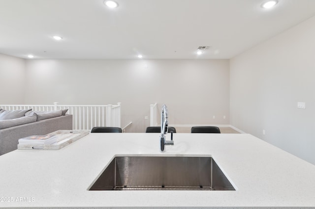155 N Lakeview Blvd Unit 268, Chandler, AZ 85225 - kitchen featuring a sink, open floor plan, recessed lighting, light stone counters, and baseboards