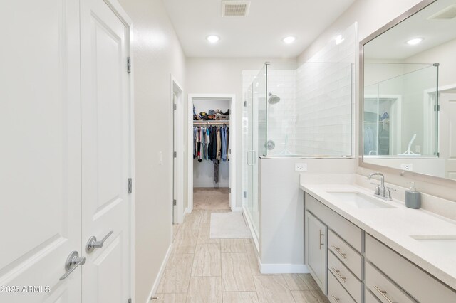 155 N Lakeview Blvd Unit 268, Chandler, AZ 85225 - bathroom with a stall shower, double vanity, a walk in closet, baseboards, and marble look tile flooring