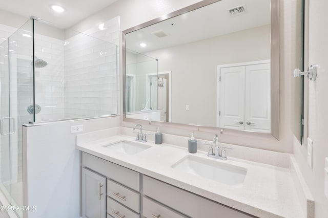155 N Lakeview Blvd Unit 268, Chandler, AZ 85225 - bathroom with a shower stall, double vanity, and recessed lighting