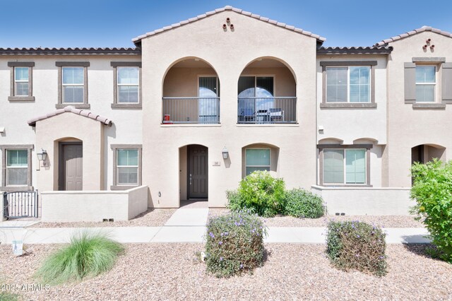 155 N Lakeview Blvd Unit 268, Chandler, AZ 85225 - view of front of home with a tiled roof, stucco siding, fence, and a balcony