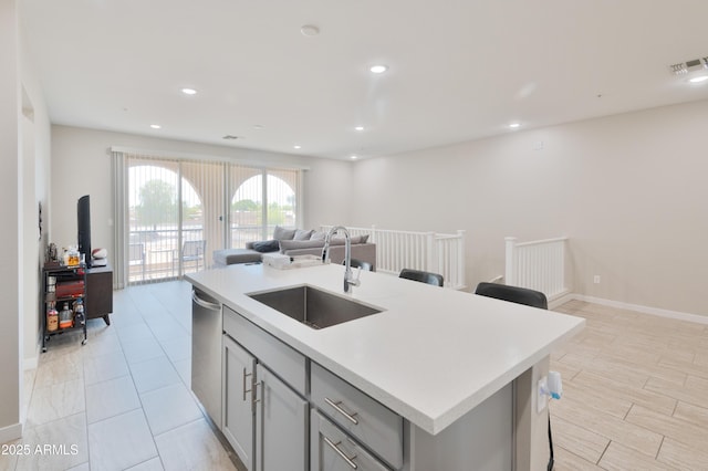155 N Lakeview Blvd Unit 268, Chandler, AZ 85225 - kitchen with a sink, gray cabinets, open floor plan, light countertops, and an island with sink