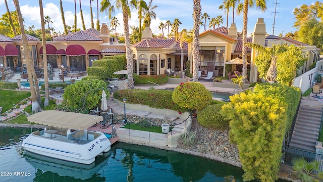 back of property featuring a water view