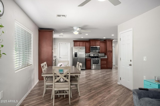 dining space featuring dark wood-type flooring, a ceiling fan, visible vents, and recessed lighting