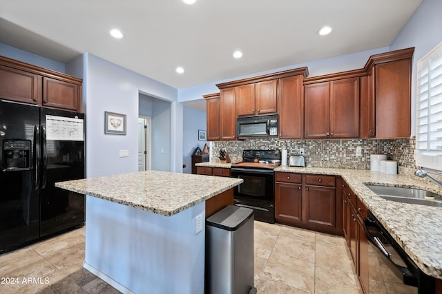 kitchen featuring a center island, a sink, black appliances, backsplash, and recessed lighting