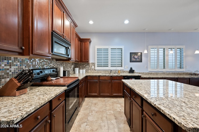 kitchen featuring recessed lighting, a sink, backsplash, light stone countertops, and black appliances