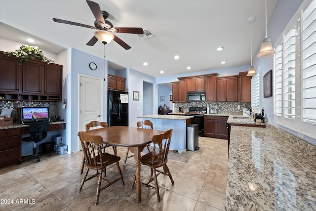 kitchen featuring a kitchen island, a sink, visible vents, black appliances, and built in desk